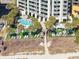 Aerial view of resort pool, lounge chairs, landscaping and white multi-story building at 2700 N Ocean Blvd. # 1053, Myrtle Beach, SC 29577