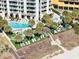 Aerial view of resort pool, lounge chairs, landscaping and white multi-story building at 2700 N Ocean Blvd. # 1053, Myrtle Beach, SC 29577