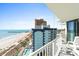 Coastal condo balcony view overlooks the beach, pier, pool, and nearby buildings at 2700 N Ocean Blvd. # 1053, Myrtle Beach, SC 29577
