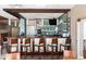 Hotel bar featuring counter seating and glass shelves with a tiled backsplash at 2700 N Ocean Blvd. # 1053, Myrtle Beach, SC 29577