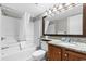 Well-lit bathroom with shower and tub combo, granite vanity, and decorative mirror at 2700 N Ocean Blvd. # 1053, Myrtle Beach, SC 29577