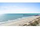 Scenic beach view featuring a long pier in the distance with blue skies at 2700 N Ocean Blvd. # 1053, Myrtle Beach, SC 29577