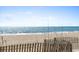 Scenic view of a tranquil beach with ocean waves and fence overlooking the water at 2700 N Ocean Blvd. # 1053, Myrtle Beach, SC 29577