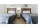 This calming bedroom is furnished with two cozy beds, lamps, and simple coastal decor at 2700 N Ocean Blvd. # 1053, Myrtle Beach, SC 29577
