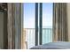 Cozy bedroom ocean-view balcony with a chair and view out sliding glass door at 2700 N Ocean Blvd. # 1053, Myrtle Beach, SC 29577