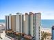 Exterior daytime view of a condo building with palm trees and well maintained landscaping at 2700 N Ocean Blvd. # 1053, Myrtle Beach, SC 29577