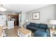 Cozy living room features a blue sofa and seamlessly connects to an efficient, compact kitchen at 2700 N Ocean Blvd. # 1053, Myrtle Beach, SC 29577
