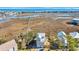 Stunning aerial view of a charming beach house nestled amidst lush marshland, with a pier at 3 Half Shell Ct., Pawleys Island, SC 29585