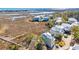 Picturesque aerial view of a serene beach house nestled amidst marshland, near the tranquil ocean at 3 Half Shell Ct., Pawleys Island, SC 29585