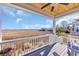 Inviting back porch boasts wood ceiling and fan overlooking scenic wetlands and distant neighborhood at 3 Half Shell Ct., Pawleys Island, SC 29585