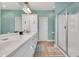 Bright bathroom with double sinks, modern vanity, walk-in shower with glass door, and neutral tiling at 3 Half Shell Ct., Pawleys Island, SC 29585