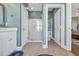 Bright bathroom features a glass shower, neutral tile, and stylish fixtures with adjacent lavatory room at 3 Half Shell Ct., Pawleys Island, SC 29585