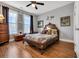 Inviting bedroom features a decorative bed, wood floors, and bright natural lighting at 3 Half Shell Ct., Pawleys Island, SC 29585