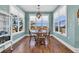Charming dining area with wood floors and bright natural light from surrounding windows at 3 Half Shell Ct., Pawleys Island, SC 29585
