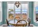 Well-lit dining area with marsh views through a large bright window at 3 Half Shell Ct., Pawleys Island, SC 29585