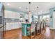 Well-lit kitchen featuring white cabinets, a center island with seating, and hardwood flooring at 3 Half Shell Ct., Pawleys Island, SC 29585