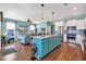 Bright and open kitchen featuring a large center island, stainless steel appliances, and wood floors at 3 Half Shell Ct., Pawleys Island, SC 29585