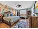 Spacious primary bedroom offers detailed wallpaper, a sitting area, and a large window at 3 Half Shell Ct., Pawleys Island, SC 29585