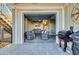 Relaxing covered outdoor living area with wicker furniture, grill, and access to the home's interior at 3 Half Shell Ct., Pawleys Island, SC 29585