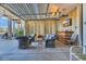 Inviting covered outdoor living space with wicker furniture and a wet bar, perfect for relaxing and entertaining at 3 Half Shell Ct., Pawleys Island, SC 29585