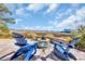 Comfortable outdoor patio with Adirondack chairs surrounding a fire pit, overlooking a marsh view at 3 Half Shell Ct., Pawleys Island, SC 29585