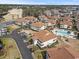 Aerial view of white condos with red roofs, parking, a pool, trees and a golf course in the background at 300 Shorehaven Dr. # W-3, North Myrtle Beach, SC 29582