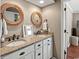 Bathroom featuring double sinks, granite countertops, and framed mirrors for a luxurious feel at 300 Shorehaven Dr. # W-3, North Myrtle Beach, SC 29582