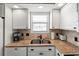 Well-equipped kitchen with granite countertops, white cabinets, and a stainless steel sink at 300 Shorehaven Dr. # W-3, North Myrtle Beach, SC 29582