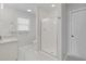 Bright bathroom featuring a glass enclosed shower, grey tile flooring, and white cabinets at 3120 Bayhaven Dr., Myrtle Beach, SC 29579