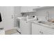 Clean laundry room with modern washer and dryer, white cabinets, and sink at 3120 Bayhaven Dr., Myrtle Beach, SC 29579