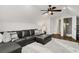 Cozy living room featuring a leather sofa, plush rug, and ceiling fan at 3120 Bayhaven Dr., Myrtle Beach, SC 29579