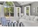 Bright living room boasting vaulted ceiling, large windows, and white and blue decor at 3120 Bayhaven Dr., Myrtle Beach, SC 29579