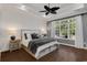 Spacious primary bedroom features a ceiling fan, a large window, and hardwood floors at 3120 Bayhaven Dr., Myrtle Beach, SC 29579