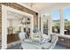 Bright sunroom features brick accent wall, modern lighting, tile floors, and views of the kitchen and landscaped yard at 3120 Bayhaven Dr., Myrtle Beach, SC 29579