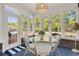 Sunroom has brick accents, multiple windows, and a glass table with wicker chairs at 3120 Bayhaven Dr., Myrtle Beach, SC 29579