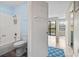 Bathroom entryway showcasing a shower-tub combo with a gray toilet and view to the living room at 310 5Th Ave. N # 206, Surfside Beach, SC 29575