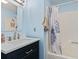Upgraded bathroom with a vanity, a tub-shower combination with curtain, and blue walls at 310 5Th Ave. N # 206, Surfside Beach, SC 29575