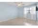 Minimalist bedroom with wood-look flooring, a ceiling fan, and a window with white curtains at 310 5Th Ave. N # 206, Surfside Beach, SC 29575