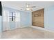 Bright bedroom with natural light, wood-look floors and blue accent wall at 310 5Th Ave. N # 206, Surfside Beach, SC 29575