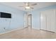 Bedroom with wood-look flooring, ceiling fan, and a closet, plus a TV mounted on the wall at 310 5Th Ave. N # 206, Surfside Beach, SC 29575