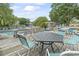 Outdoor patio and pool area with table and chairs at 310 5Th Ave. N # 206, Surfside Beach, SC 29575