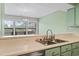Kitchen area with sink and a pass-through to a window at 310 5Th Ave. N # 206, Surfside Beach, SC 29575