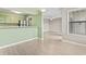 Kitchen and living area with breakfast bar, stainless steel appliances, green walls, and wood-look floors at 310 5Th Ave. N # 206, Surfside Beach, SC 29575