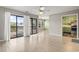 Open-concept living room flows into the kitchen and dining area, featuring wood floors and sliding glass doors to the balcony at 310 5Th Ave. N # 206, Surfside Beach, SC 29575
