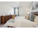 Well-lit bedroom with a large bed, wooden dresser, seascape art piece, and a comfortable accent chair at 312 Brackish Dr. # 312, Myrtle Beach, SC 29588