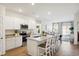 Modern kitchen with eat-in island and stainless-steel appliances that opens into a living area at 312 Brackish Dr. # 312, Myrtle Beach, SC 29588
