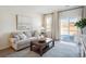 Cozy living room with comfortable seating, a wooden coffee table, and sliding glass doors at 312 Brackish Dr. # 312, Myrtle Beach, SC 29588