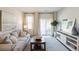 Cozy living room featuring a plush sofa, striped curtains, and a decorative rug, perfect for relaxation at 312 Brackish Dr. # 312, Myrtle Beach, SC 29588