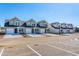 Row of townhomes featuring a modern aesthetic, well-maintained landscaping, and ample parking spaces at 312 Brackish Dr. # 312, Myrtle Beach, SC 29588