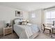 Inviting bedroom featuring a queen bed with soft linens, a nightstand, and a window with natural light at 316 Brackish Dr. # 316, Myrtle Beach, SC 29588